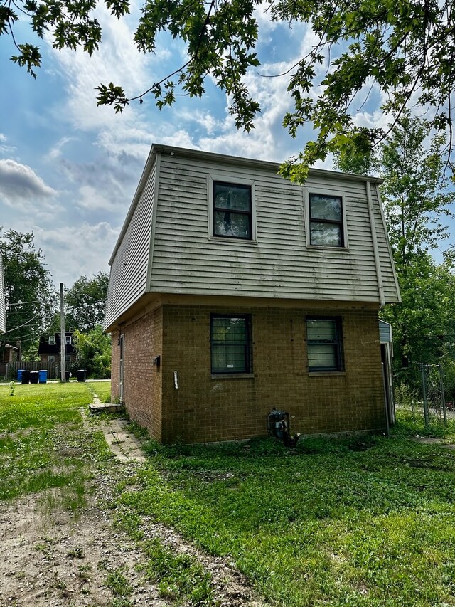 view of side of home with a lawn