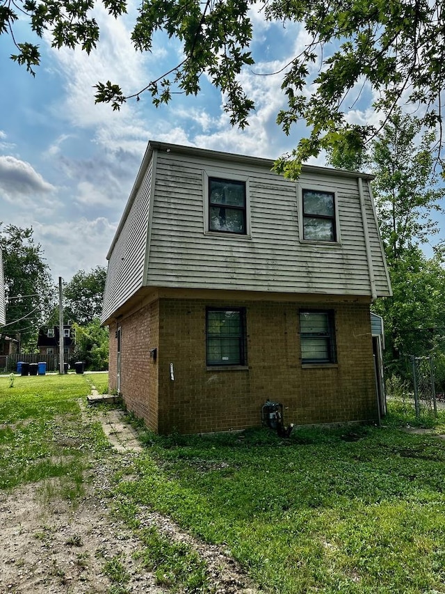 355 W 105th Pl, Chicago, IL 60628 - back of house with brick siding and a lawn