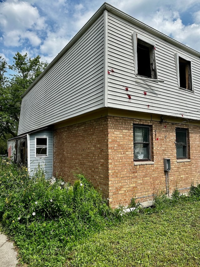 view of side of home featuring a yard