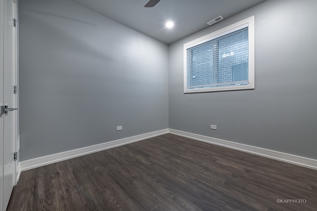 spare room featuring ceiling fan and dark hardwood / wood-style floors