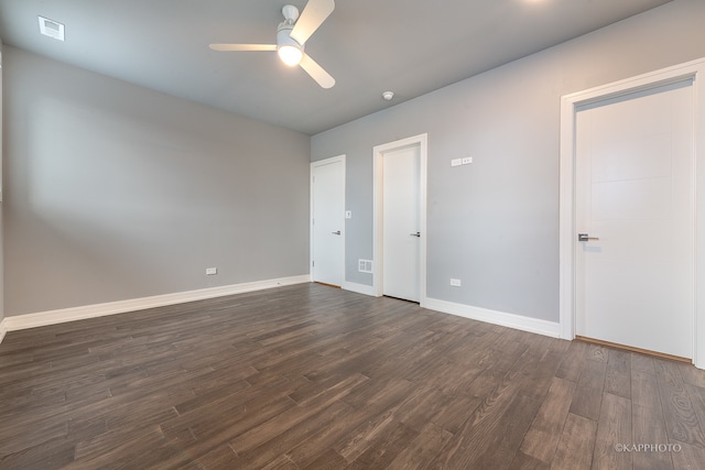 spare room featuring dark hardwood / wood-style flooring and ceiling fan