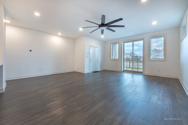 empty room with dark hardwood / wood-style flooring and ceiling fan