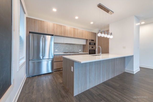 kitchen with stainless steel appliances, tasteful backsplash, dark hardwood / wood-style flooring, kitchen peninsula, and decorative light fixtures