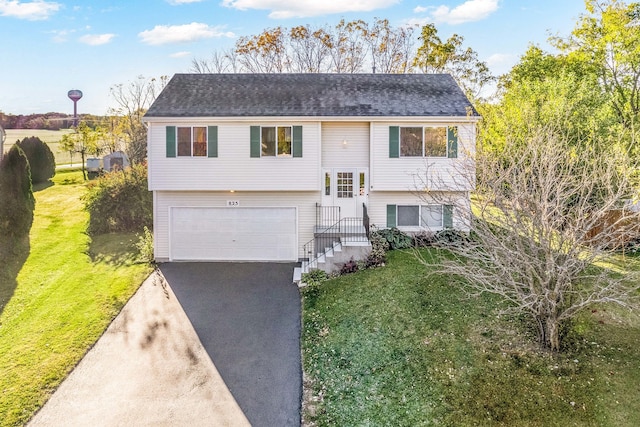 bi-level home featuring a front lawn and a garage