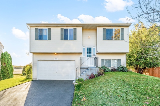 split foyer home with a front yard and a garage