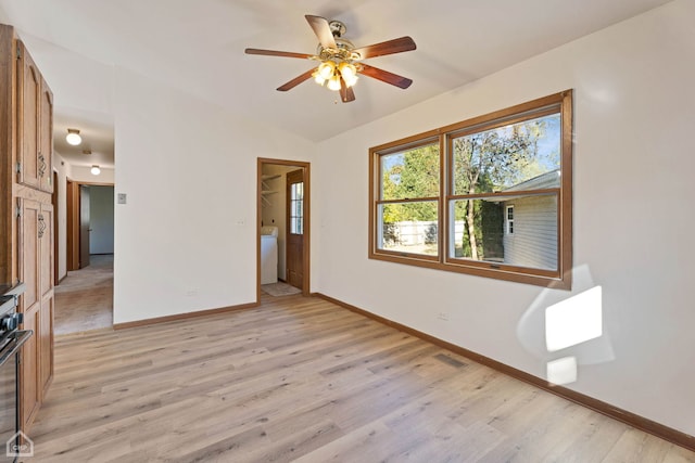 unfurnished room featuring light hardwood / wood-style floors, lofted ceiling, and ceiling fan