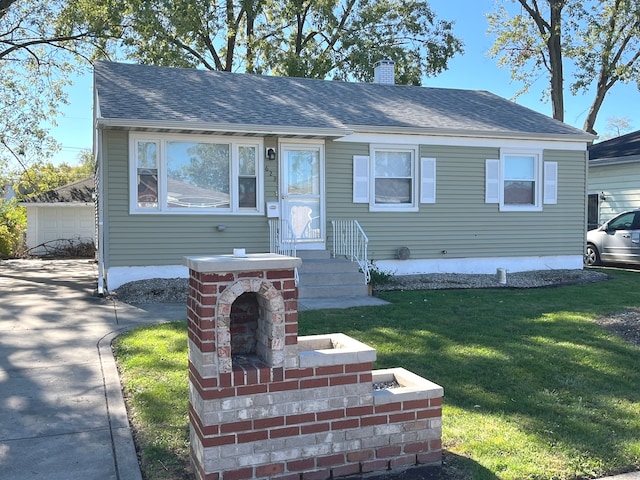 view of front of property with a front lawn and a garage