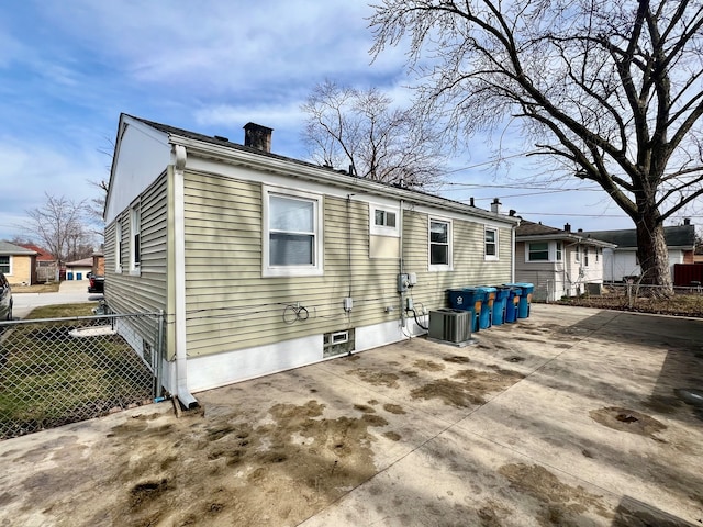 rear view of house with a patio and central AC