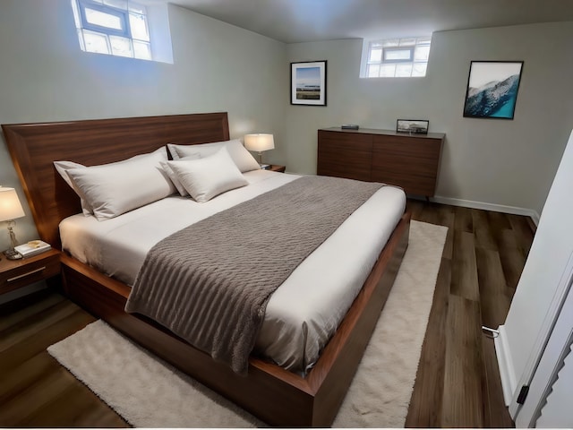 bedroom with dark hardwood / wood-style floors