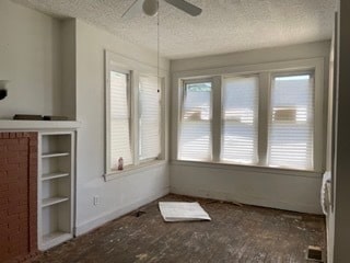 interior space featuring ceiling fan, a textured ceiling, and hardwood / wood-style floors