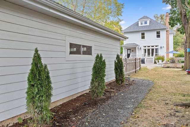 back of house featuring a yard and fence