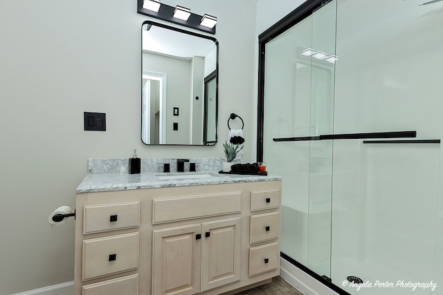 bathroom featuring vanity, hardwood / wood-style flooring, and walk in shower