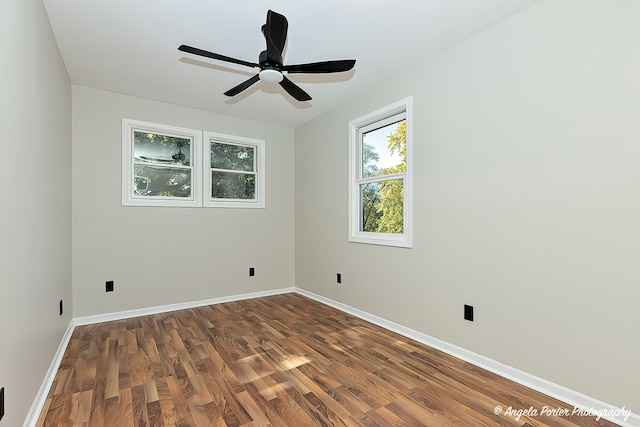 empty room with ceiling fan and dark hardwood / wood-style floors