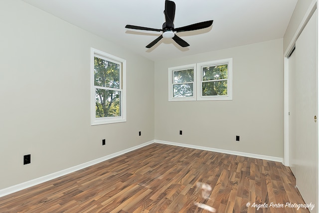 unfurnished bedroom featuring ceiling fan and dark hardwood / wood-style floors