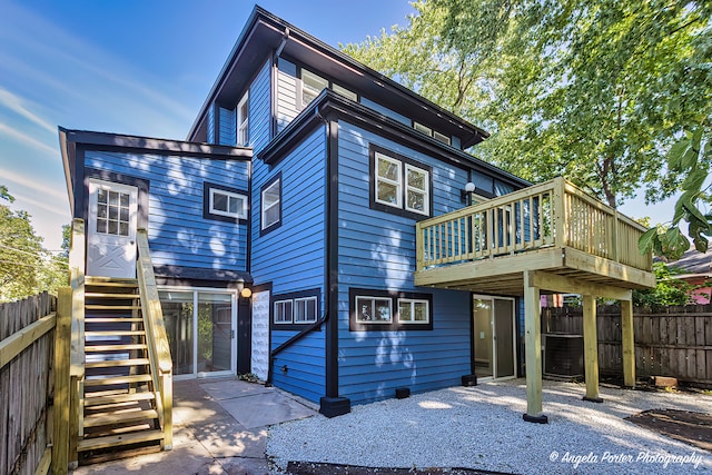 rear view of house featuring a patio area, a wooden deck, and central AC unit