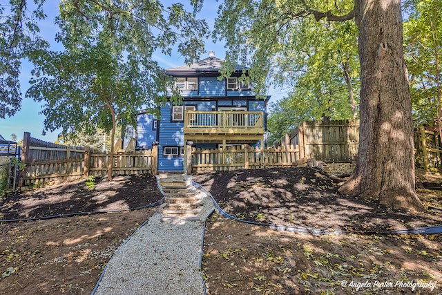 rear view of property featuring a deck