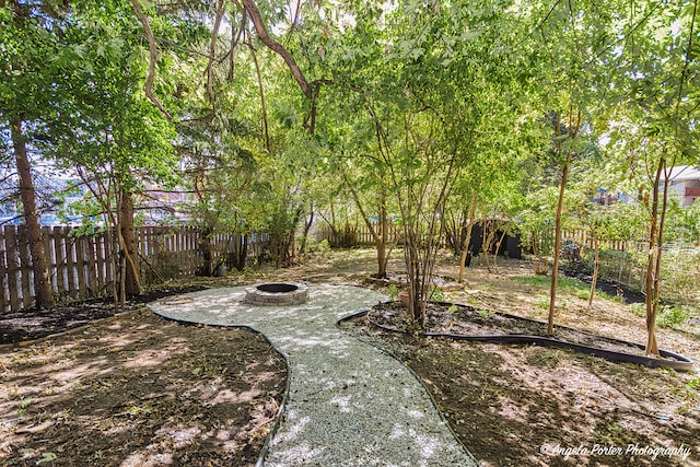 view of yard featuring an outdoor fire pit