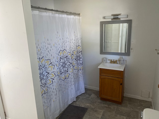 bathroom with vanity, toilet, and walk in shower