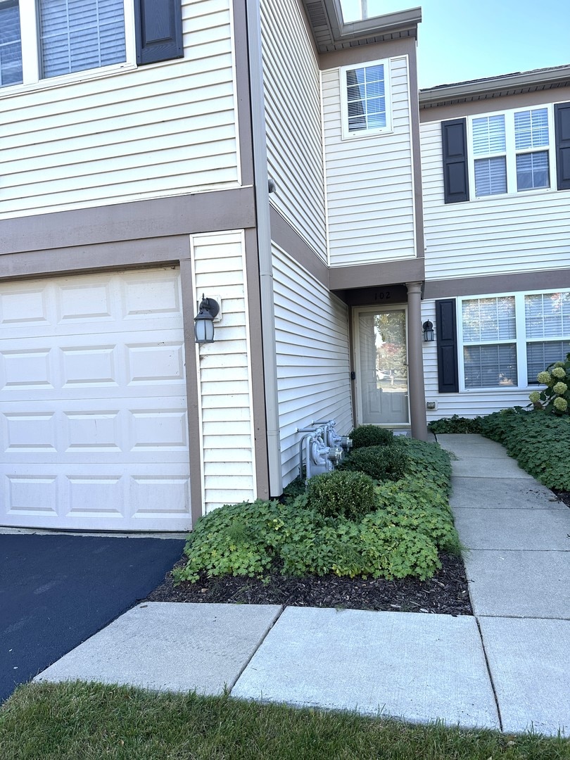 view of exterior entry with a garage