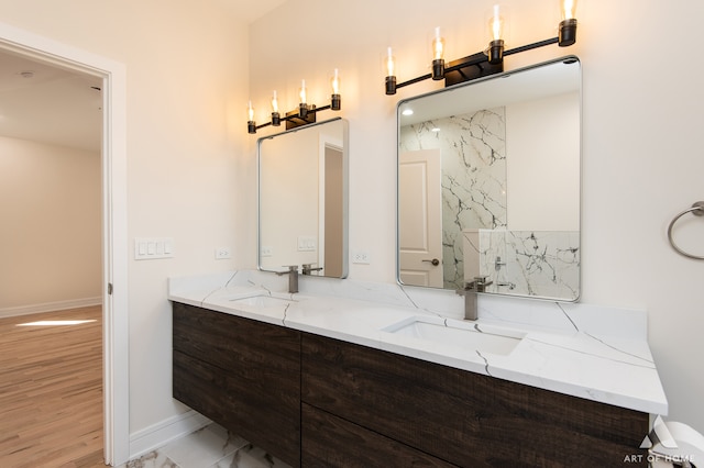 bathroom featuring vanity, water heater, and wood-type flooring