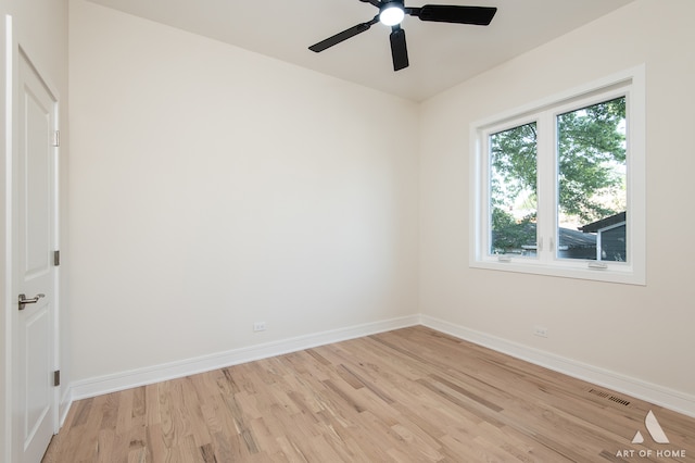 spare room with light wood-type flooring and ceiling fan