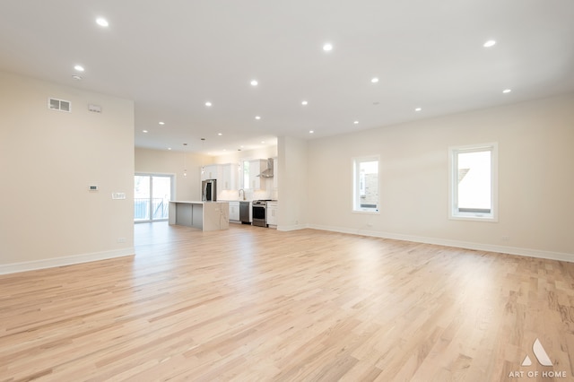 unfurnished living room featuring light hardwood / wood-style flooring