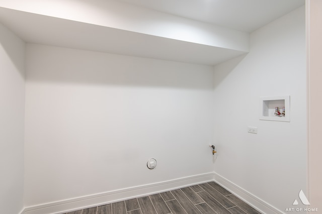 clothes washing area with hookup for a gas dryer, washer hookup, and dark hardwood / wood-style flooring