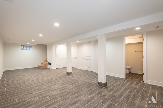 basement with dark hardwood / wood-style floors