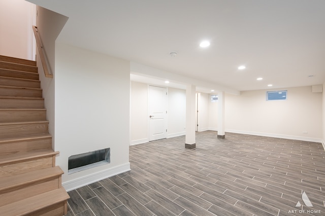 basement with dark hardwood / wood-style floors