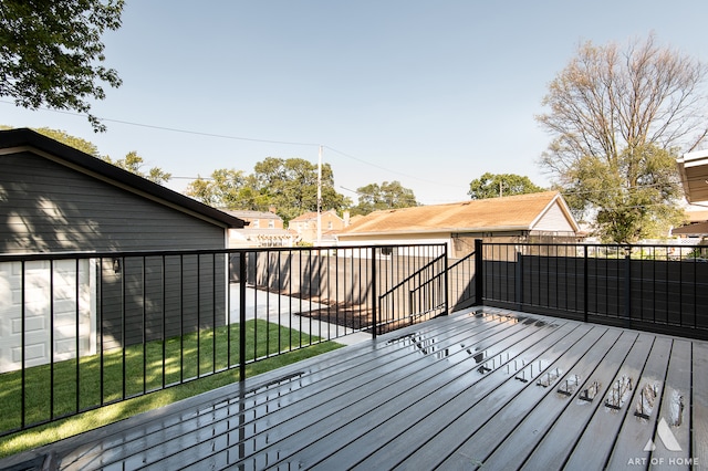 wooden terrace featuring a yard