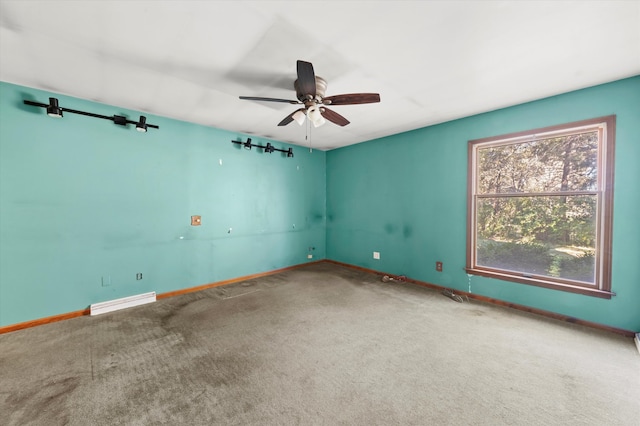 unfurnished room with ceiling fan and carpet flooring