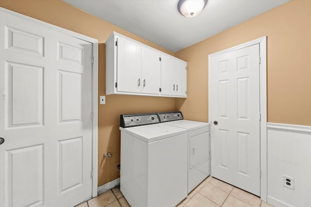 washroom with light tile patterned floors, cabinets, and independent washer and dryer