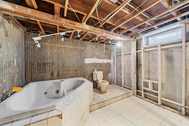 1940 W Eagle Lake Rd, Beecher, IL 60401 - bathroom featuring wooden walls, tile patterned floors, a whirlpool tub, and toilet