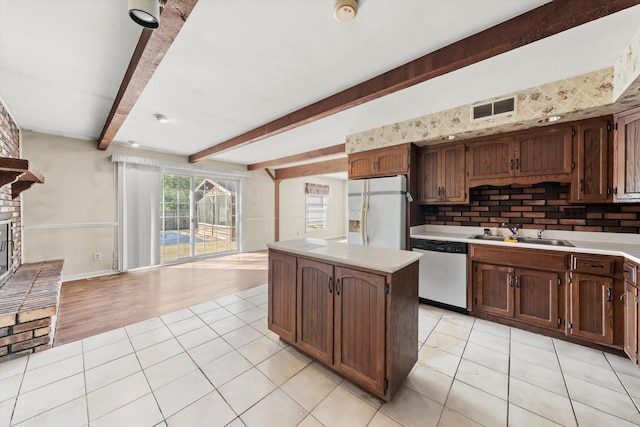 1940 W Eagle Lake Rd, Beecher, IL 60401 - kitchen featuring a sink, dishwasher, white fridge with ice dispenser, a center island, and visible vents