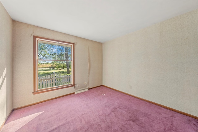 carpeted empty room featuring a baseboard radiator