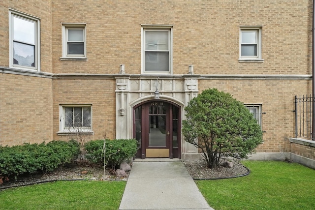 doorway to property featuring a yard