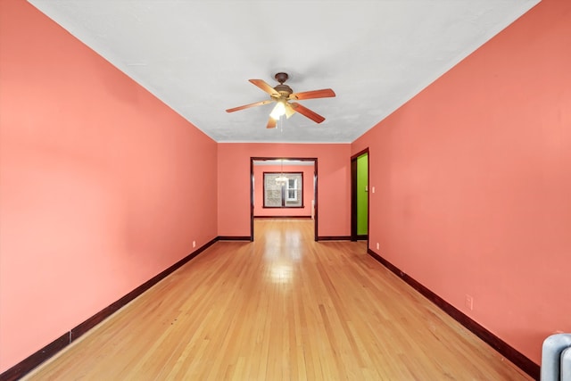 spare room featuring light hardwood / wood-style flooring and ceiling fan