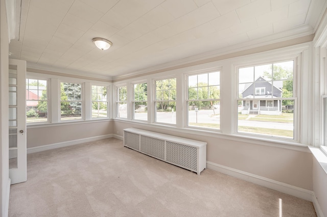 unfurnished sunroom featuring a wealth of natural light and radiator