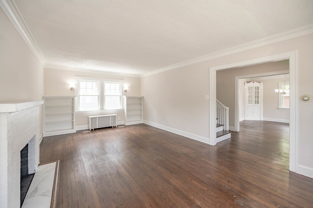 unfurnished living room with radiator, ornamental molding, a brick fireplace, a textured ceiling, and dark hardwood / wood-style flooring