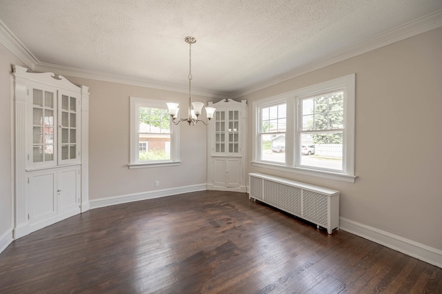 unfurnished dining area featuring a chandelier, radiator heating unit, dark hardwood / wood-style floors, and a textured ceiling