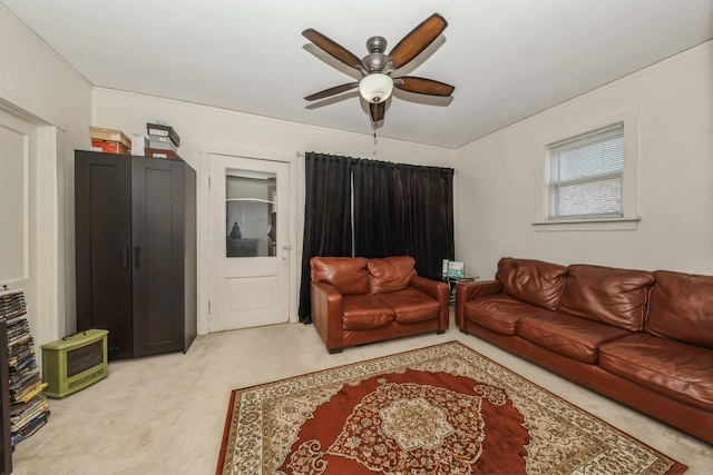 carpeted living room featuring heating unit and ceiling fan