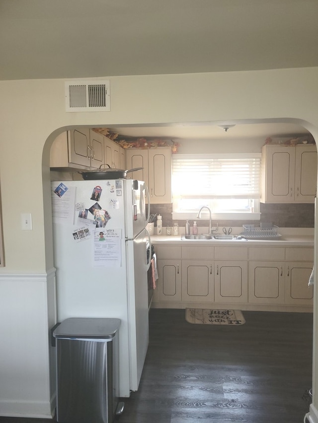 kitchen featuring tasteful backsplash, dark hardwood / wood-style floors, white fridge, and sink