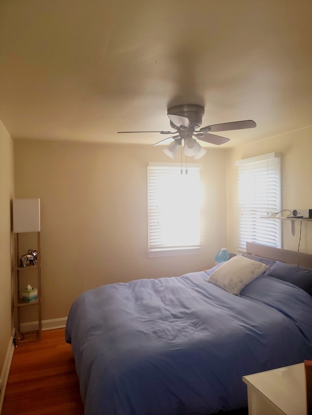 bedroom featuring ceiling fan and dark hardwood / wood-style flooring