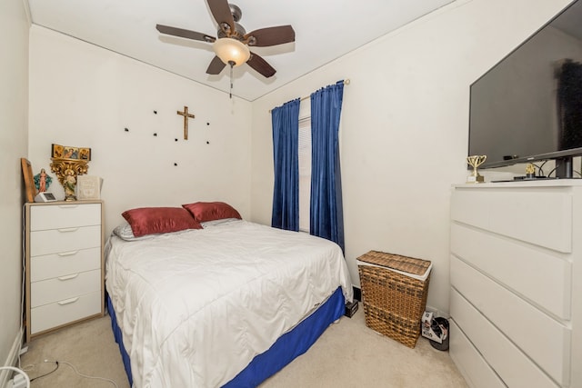 bedroom with ceiling fan and light carpet