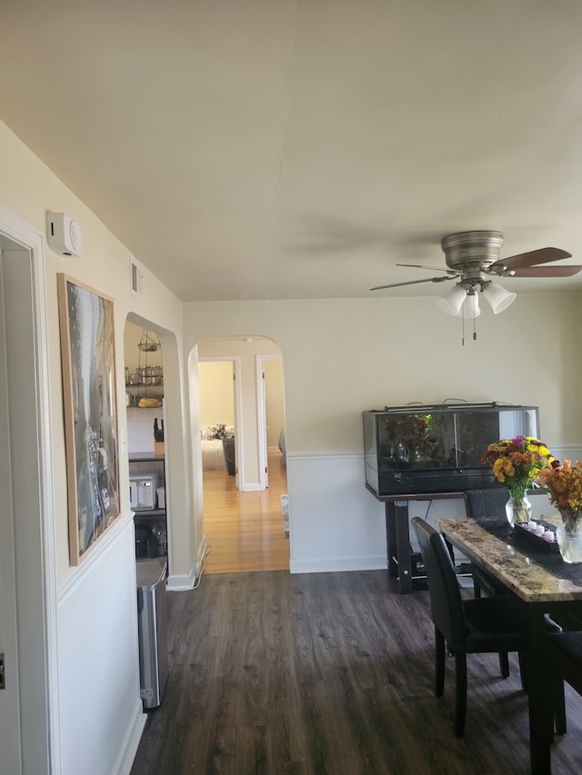 dining area featuring dark wood-type flooring and ceiling fan