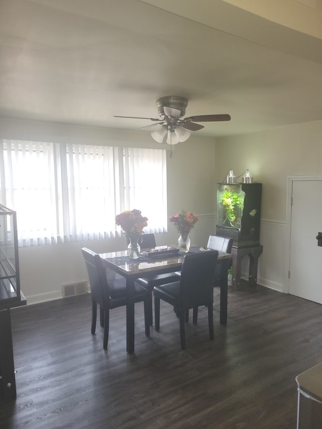 dining space with ceiling fan and dark hardwood / wood-style floors