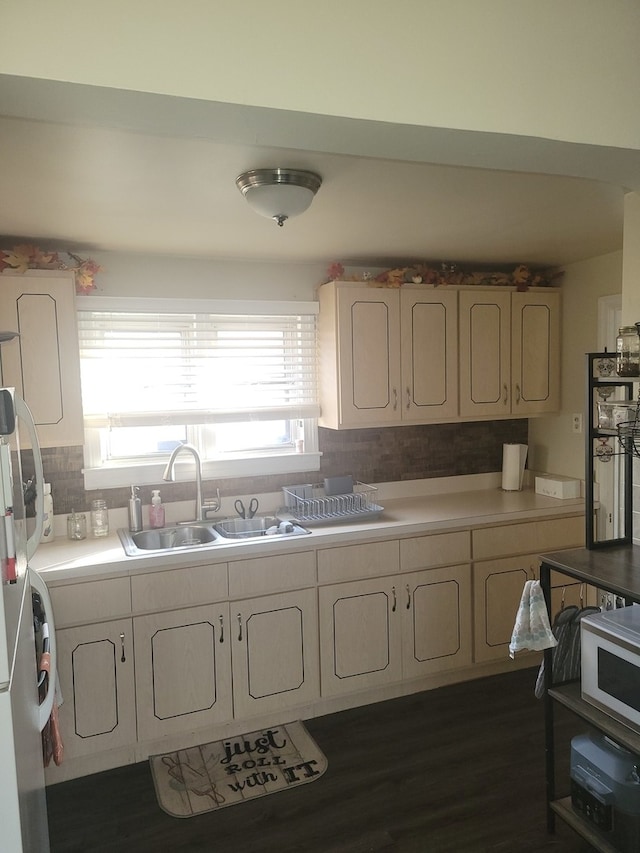 kitchen featuring tasteful backsplash, stainless steel fridge, dark hardwood / wood-style floors, and sink