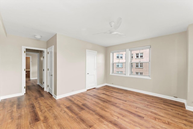 spare room featuring hardwood / wood-style flooring and ceiling fan