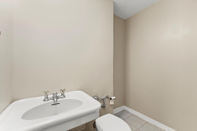 bathroom with sink, tile patterned flooring, and toilet