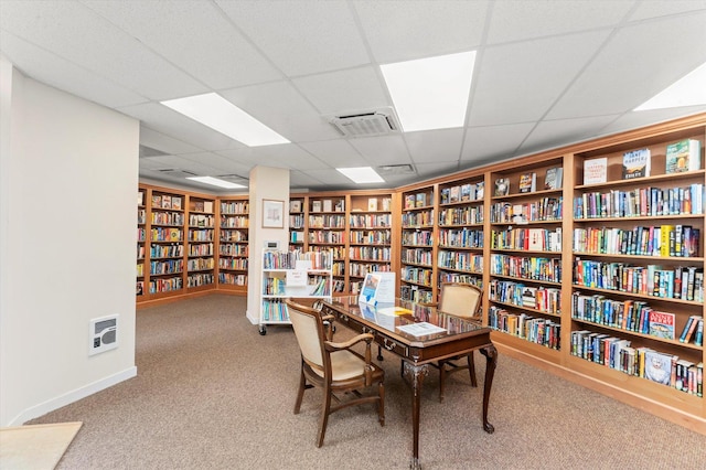 carpeted home office featuring a drop ceiling